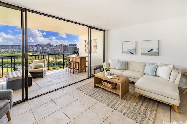 living room featuring floor to ceiling windows and light tile patterned flooring