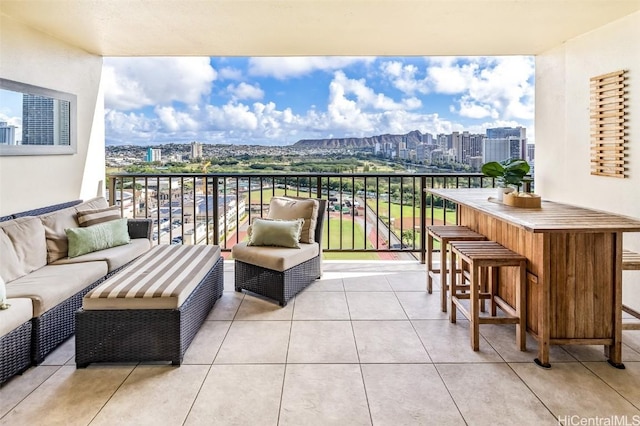 balcony with exterior bar and an outdoor hangout area