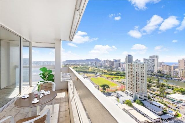 balcony featuring a view of city and a water view