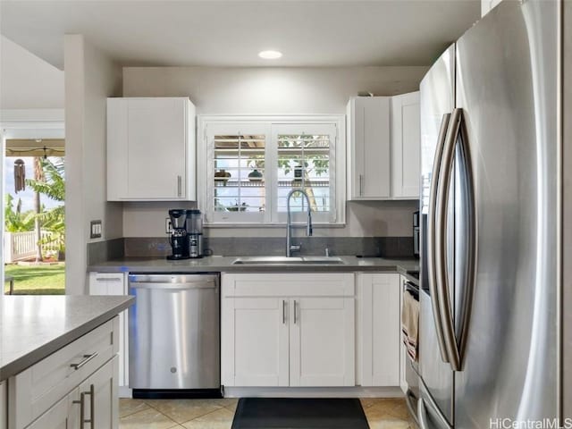 kitchen with white cabinetry, sink, and stainless steel appliances