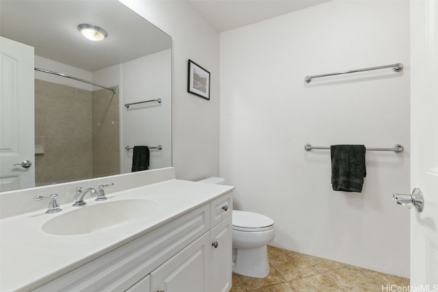 bathroom featuring tile patterned floors, vanity, toilet, and walk in shower