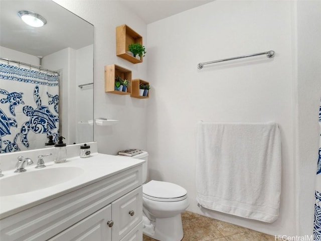 bathroom featuring tile patterned flooring, vanity, toilet, and walk in shower