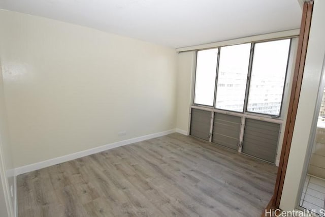 unfurnished room featuring light hardwood / wood-style floors