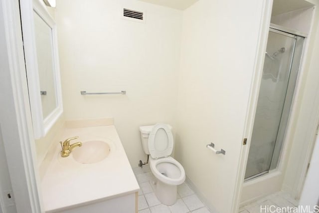 bathroom with tile patterned flooring, vanity, toilet, and walk in shower