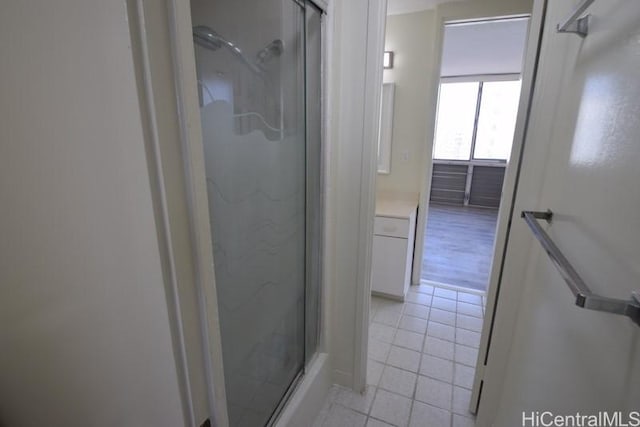 bathroom with tile patterned flooring and a shower with door