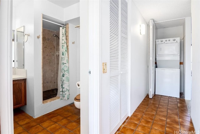 hallway with stacked washer / dryer