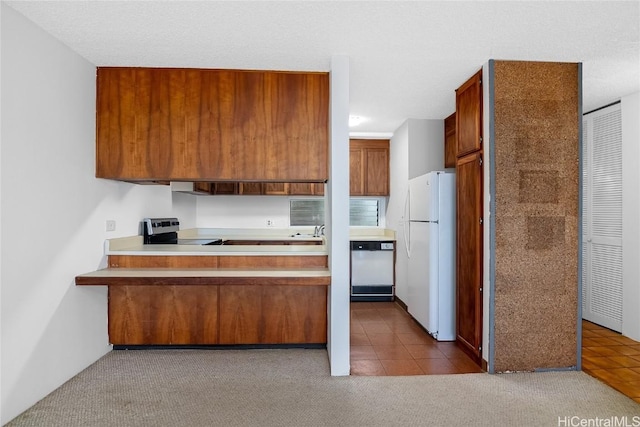 kitchen with dishwasher, white refrigerator, sink, electric range, and light tile patterned floors