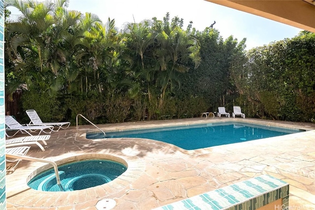 view of pool with an in ground hot tub and a patio