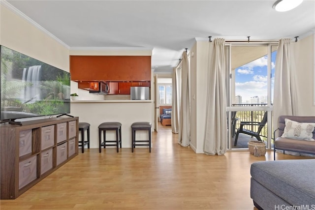 living room with floor to ceiling windows, a wealth of natural light, crown molding, and light hardwood / wood-style floors