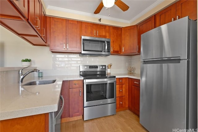 kitchen featuring light wood-type flooring, a sink, backsplash, appliances with stainless steel finishes, and crown molding