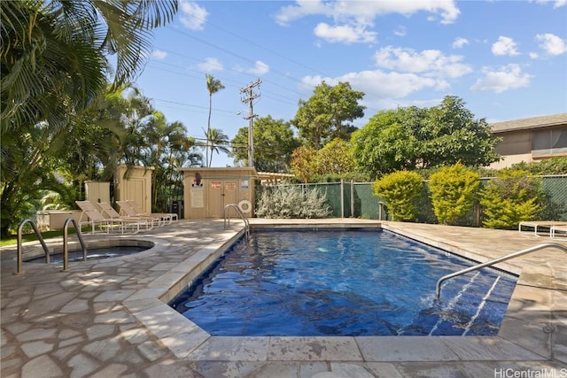 community pool with a patio and fence