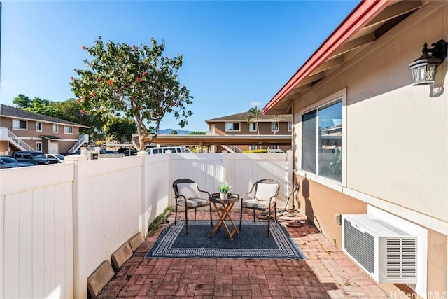 view of patio featuring a wall mounted AC