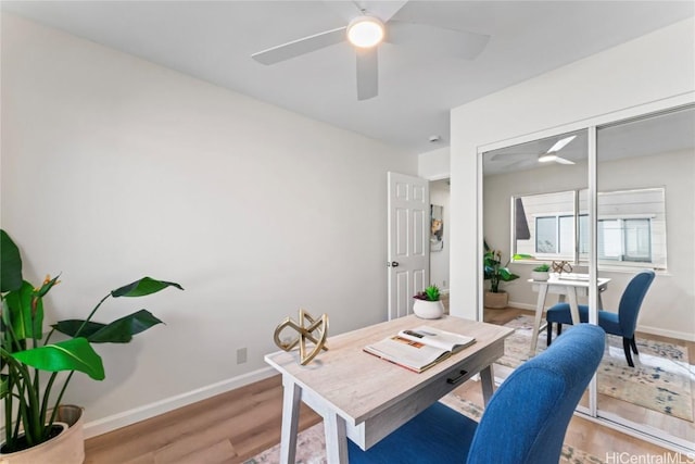 office space featuring ceiling fan and light hardwood / wood-style floors