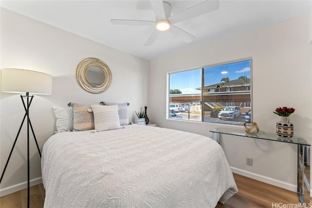 bedroom with hardwood / wood-style floors and ceiling fan