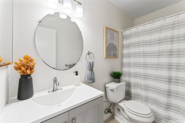 bathroom with toilet and vanity