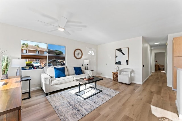 living room with light wood-type flooring and ceiling fan