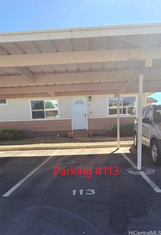 view of vehicle parking featuring a carport