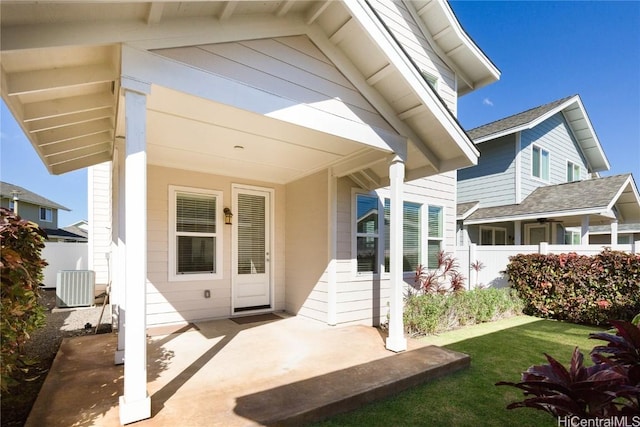 back of house with central AC unit and a patio