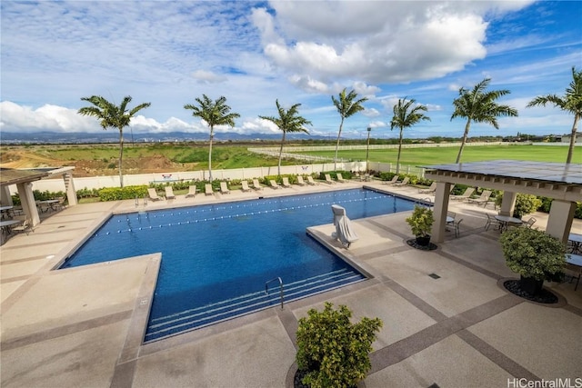 community pool featuring fence and a patio