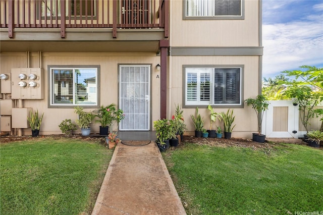 91-1022 Huliau St Unit 1A, Ewa Beach, HI 96706 - doorway to property with a balcony and a lawn