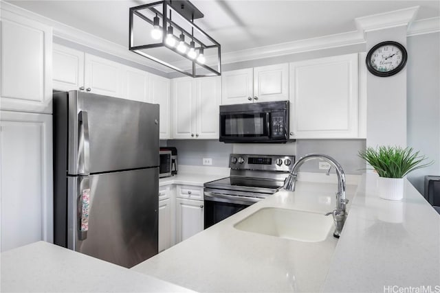 kitchen with sink, white cabinets, hanging light fixtures, ornamental molding, and stainless steel appliances