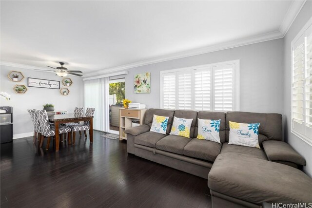 living room featuring dark wood-type flooring, ornamental molding, and ceiling fan