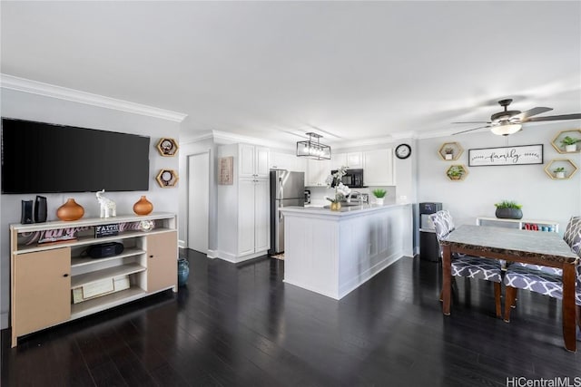 kitchen with stainless steel refrigerator, white cabinets, ornamental molding, ceiling fan, and dark wood-type flooring