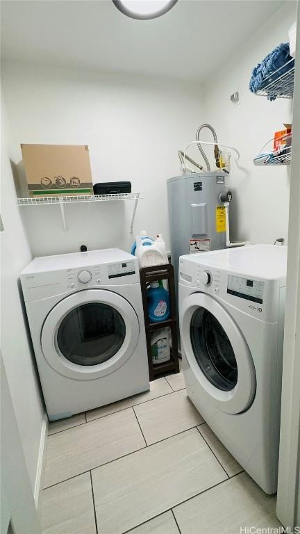 washroom featuring electric water heater and washing machine and clothes dryer