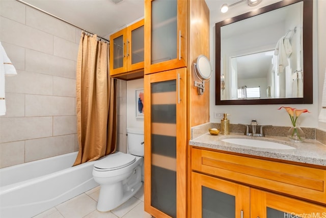 full bathroom featuring tile patterned floors, vanity, toilet, and shower / bath combo with shower curtain