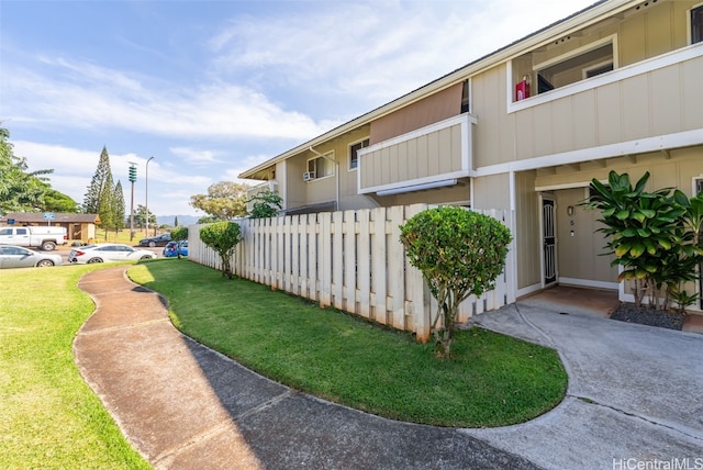 view of side of property with a lawn