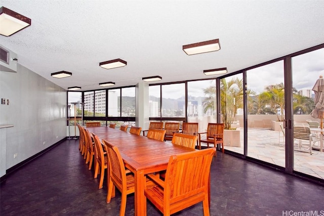 dining area featuring floor to ceiling windows and a textured ceiling