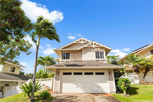 view of front of home with a front lawn and a garage