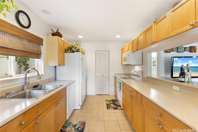 kitchen with light tile patterned flooring, white appliances, and sink