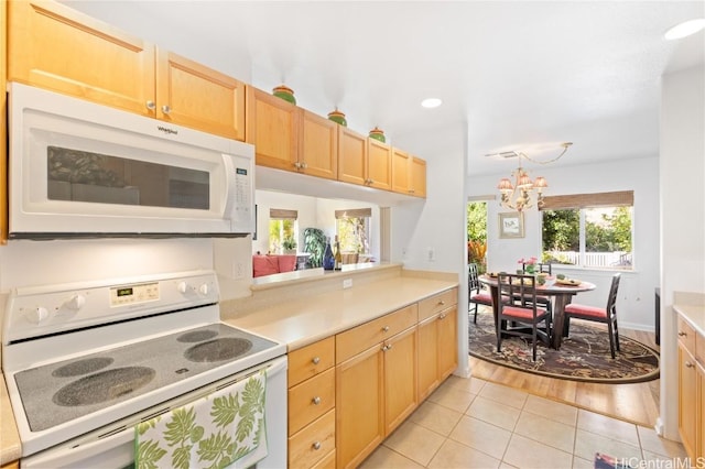 kitchen with a notable chandelier, decorative light fixtures, white appliances, light brown cabinetry, and light tile patterned flooring