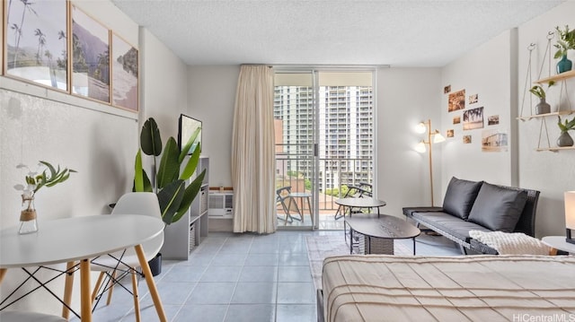 tiled bedroom featuring a wall of windows, a textured ceiling, and access to outside