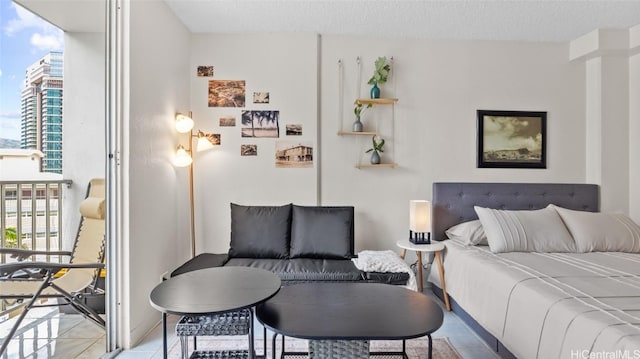 bedroom featuring light tile patterned floors, a textured ceiling, and multiple windows