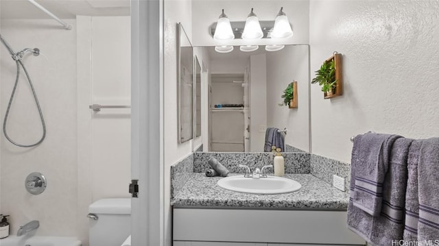 full bathroom with vanity, shower / bathtub combination, and toilet