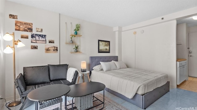 bedroom featuring light tile patterned flooring and a textured ceiling