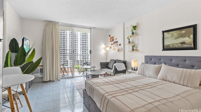 tiled bedroom featuring floor to ceiling windows, a textured ceiling, and access to exterior