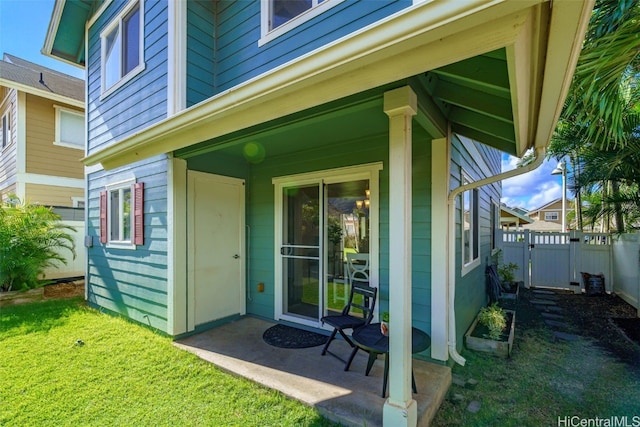 view of exterior entry featuring a lawn