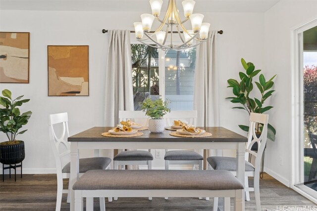 dining room featuring dark hardwood / wood-style floors and a chandelier