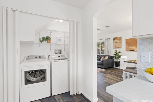 washroom with dark hardwood / wood-style flooring and washer and dryer