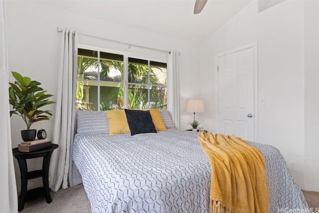 bedroom featuring vaulted ceiling, ceiling fan, and carpet flooring