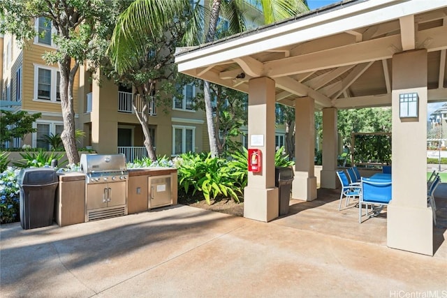 view of patio / terrace featuring a gazebo, an outdoor kitchen, and a grill