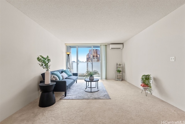 living room featuring a wall mounted air conditioner, carpet flooring, expansive windows, and a textured ceiling