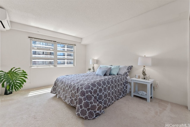 carpeted bedroom with a textured ceiling and a wall unit AC