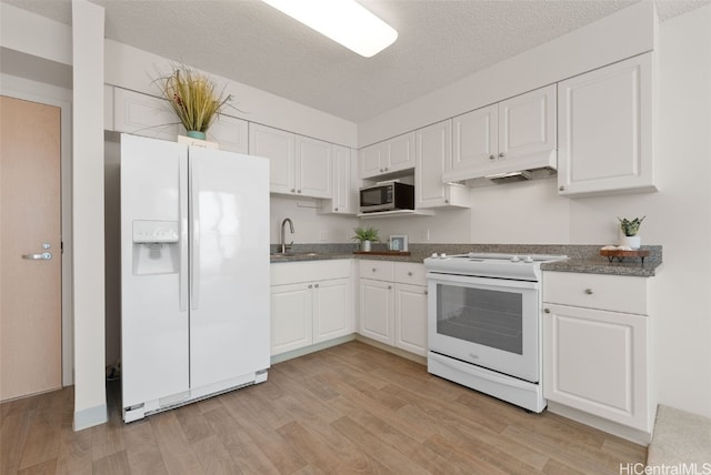 kitchen with white cabinetry, sink, light hardwood / wood-style flooring, a textured ceiling, and white appliances