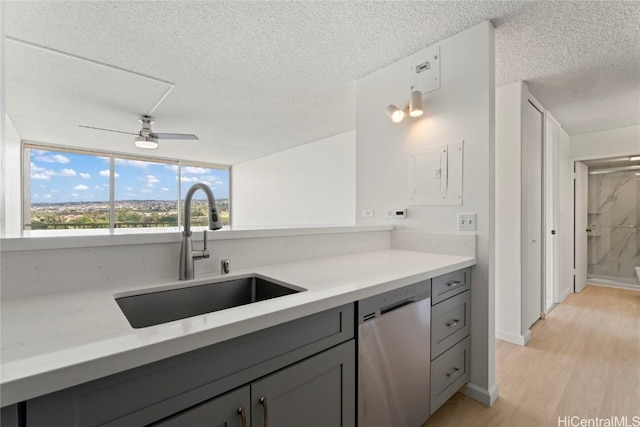 kitchen featuring gray cabinetry, ceiling fan, dishwasher, sink, and light hardwood / wood-style floors