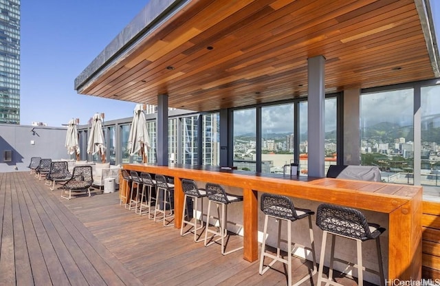 wooden terrace with an outdoor bar