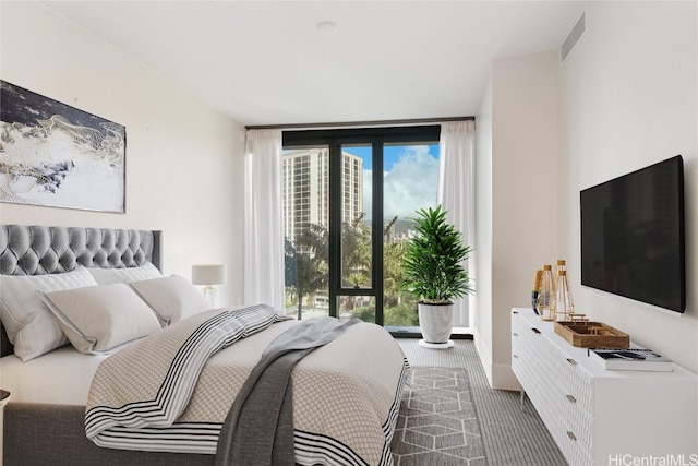 bedroom featuring carpet flooring and expansive windows